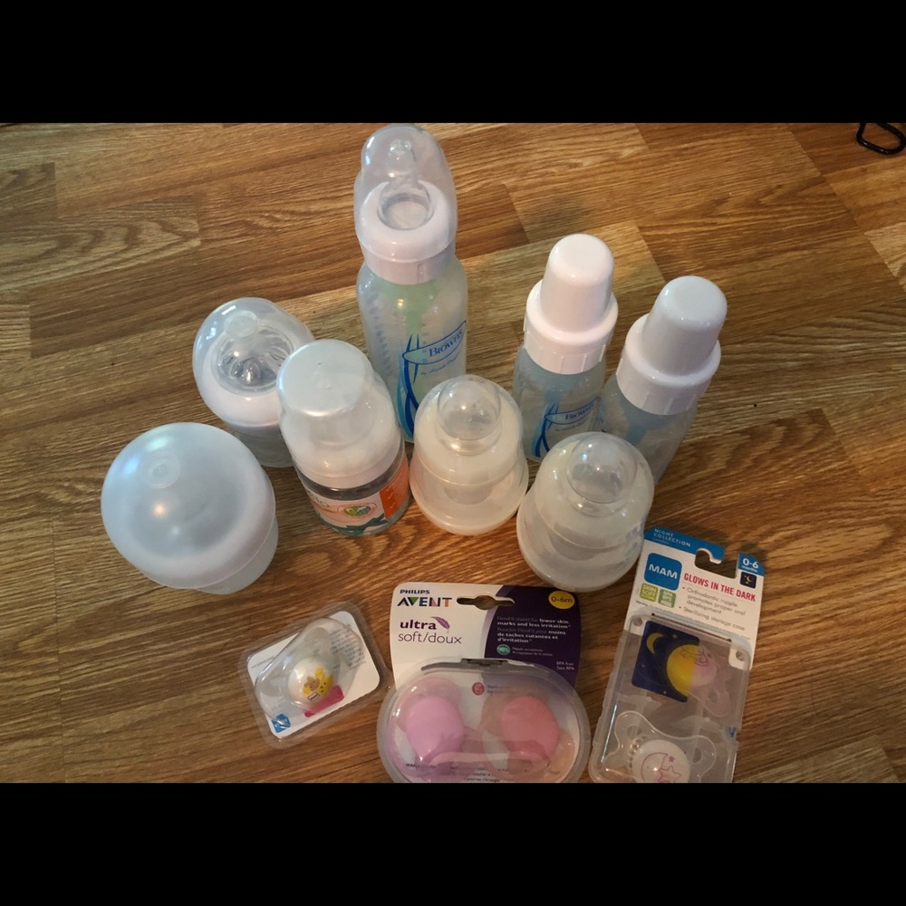 Assortment of baby bottles and pacifiers